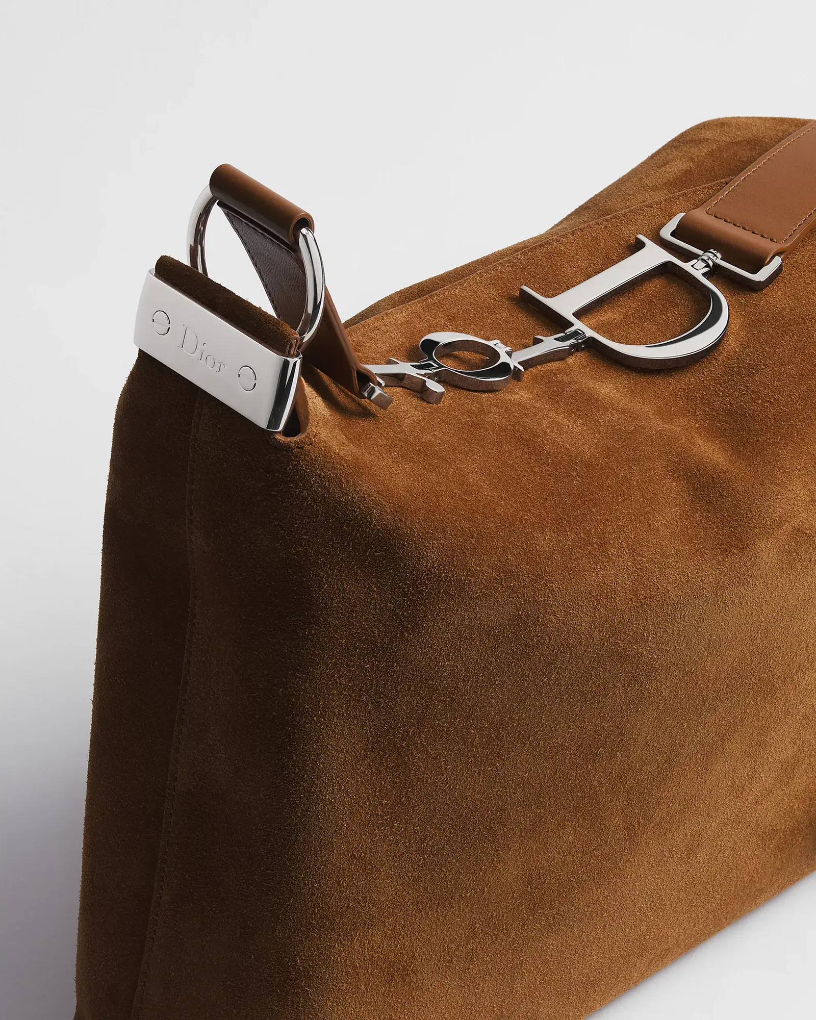 Dior suede bag, close-up of the Dior letter charm and hardware